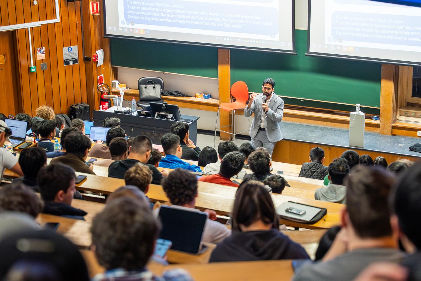 Nirajit Syamal speaking to a full lecture theatre of students
