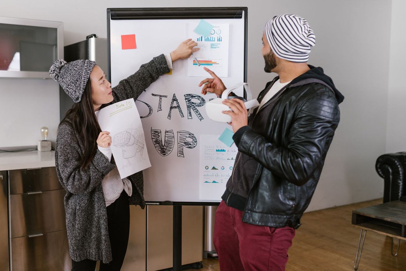 Two young people pitching an idea on a flipchart